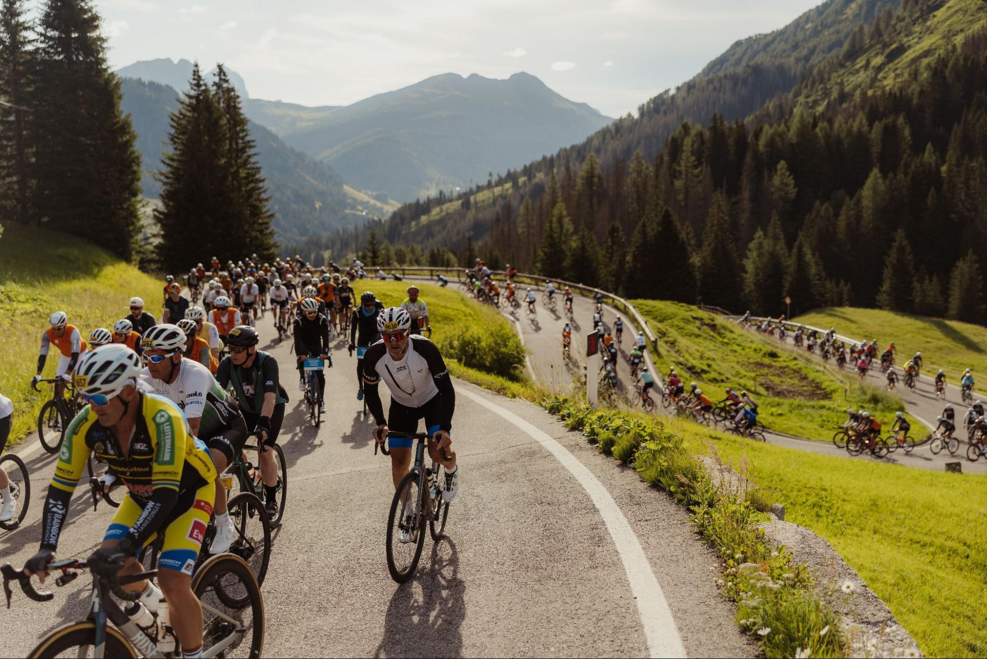 Riders pacing themselves on an early climb of the Maratona dles Dolomites