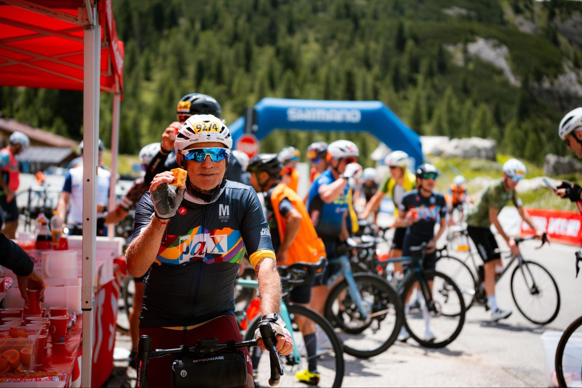 Cyclists refuelling at a feed stop before the next Dolomites pass