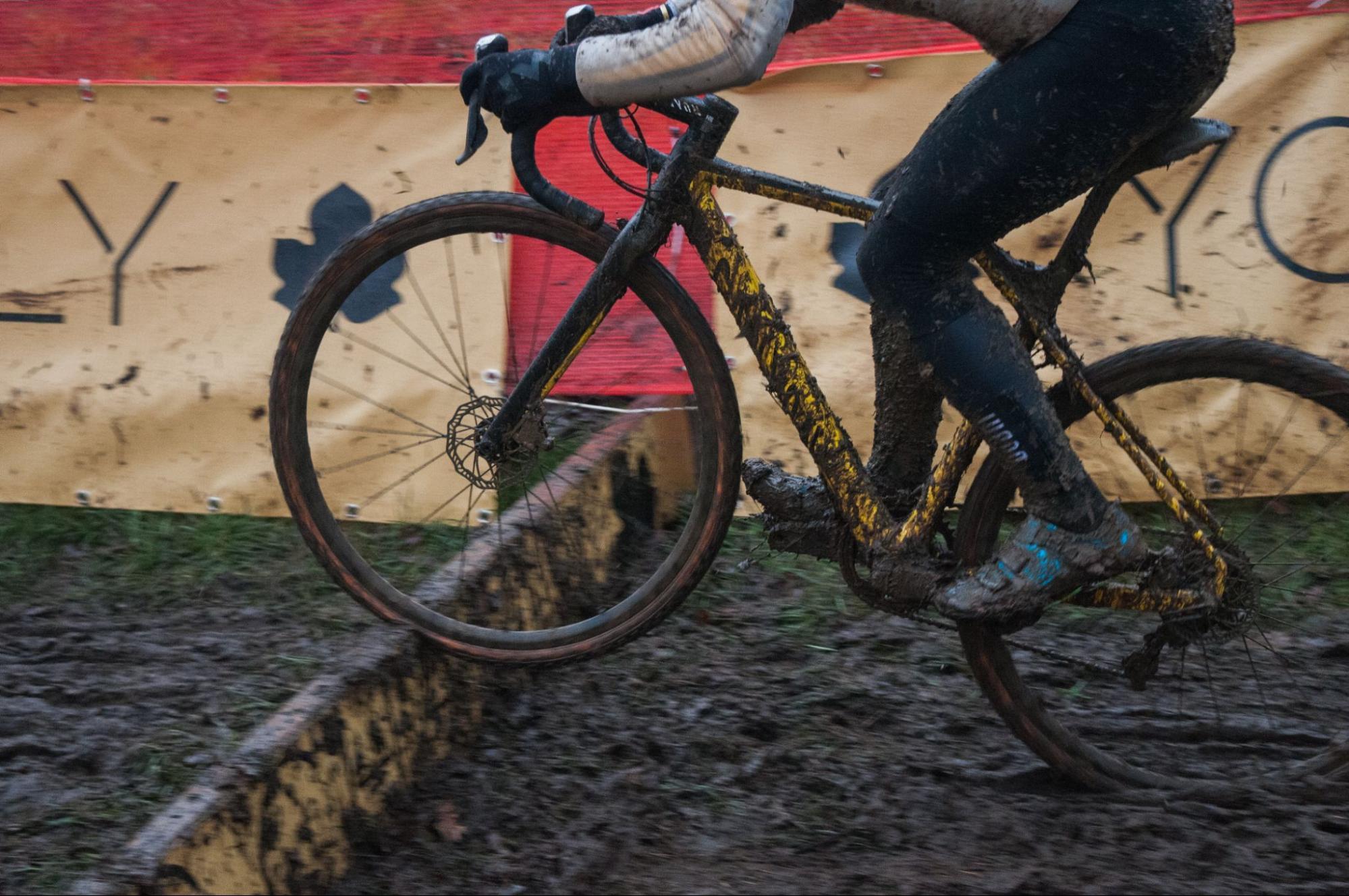 Cyclocross rider powering through deep mud, showing why cyclocross training differs from road cycling