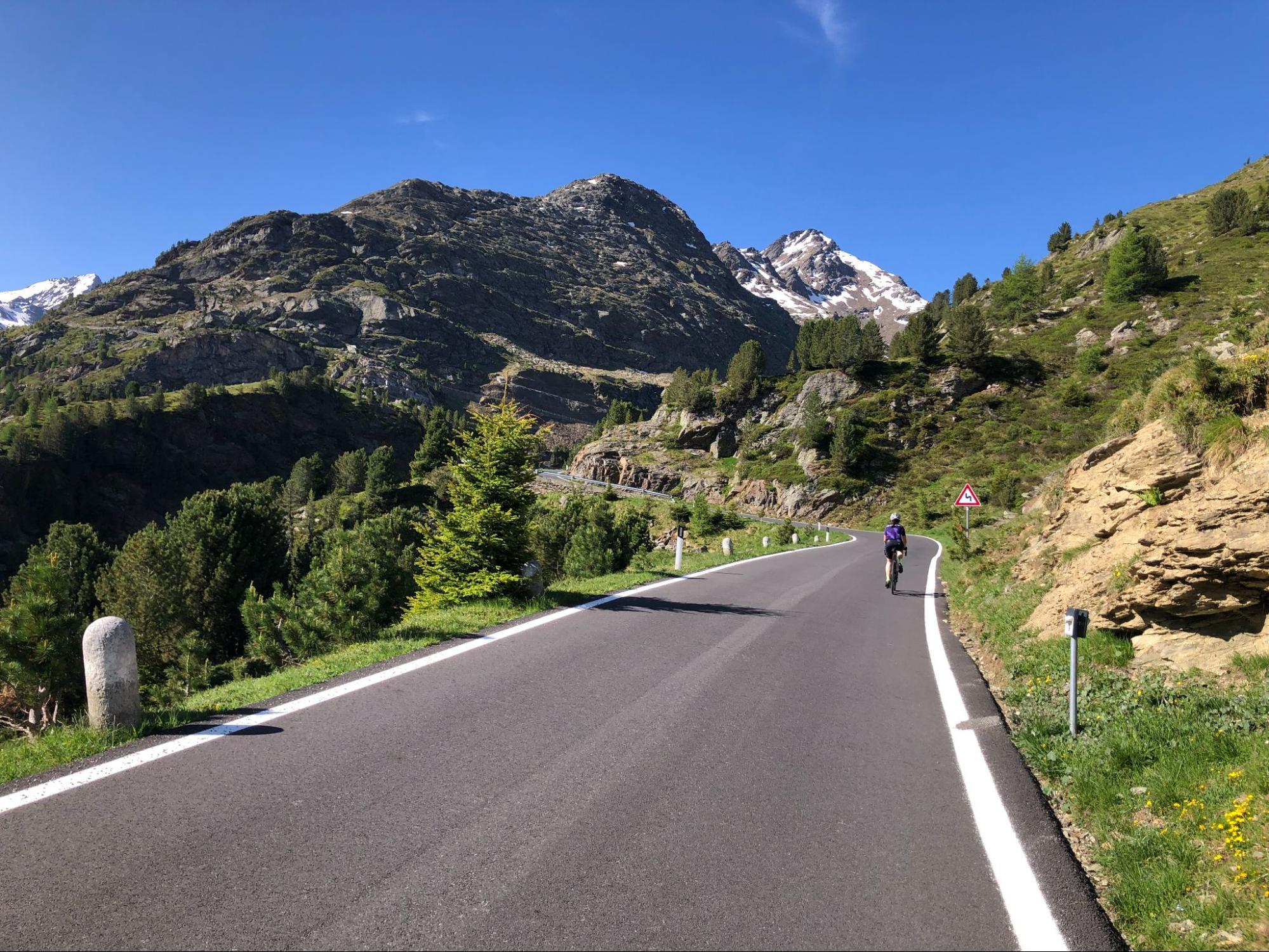 Cyclist riding a mountain road climb