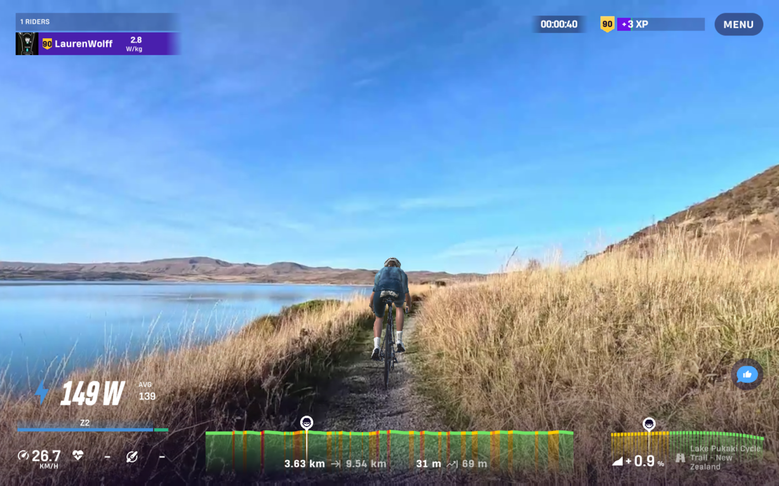 Cycling beside Lake Pukaki with Aoraki / Mount Cook, New Zealand’s highest mountain, visible across the lake.