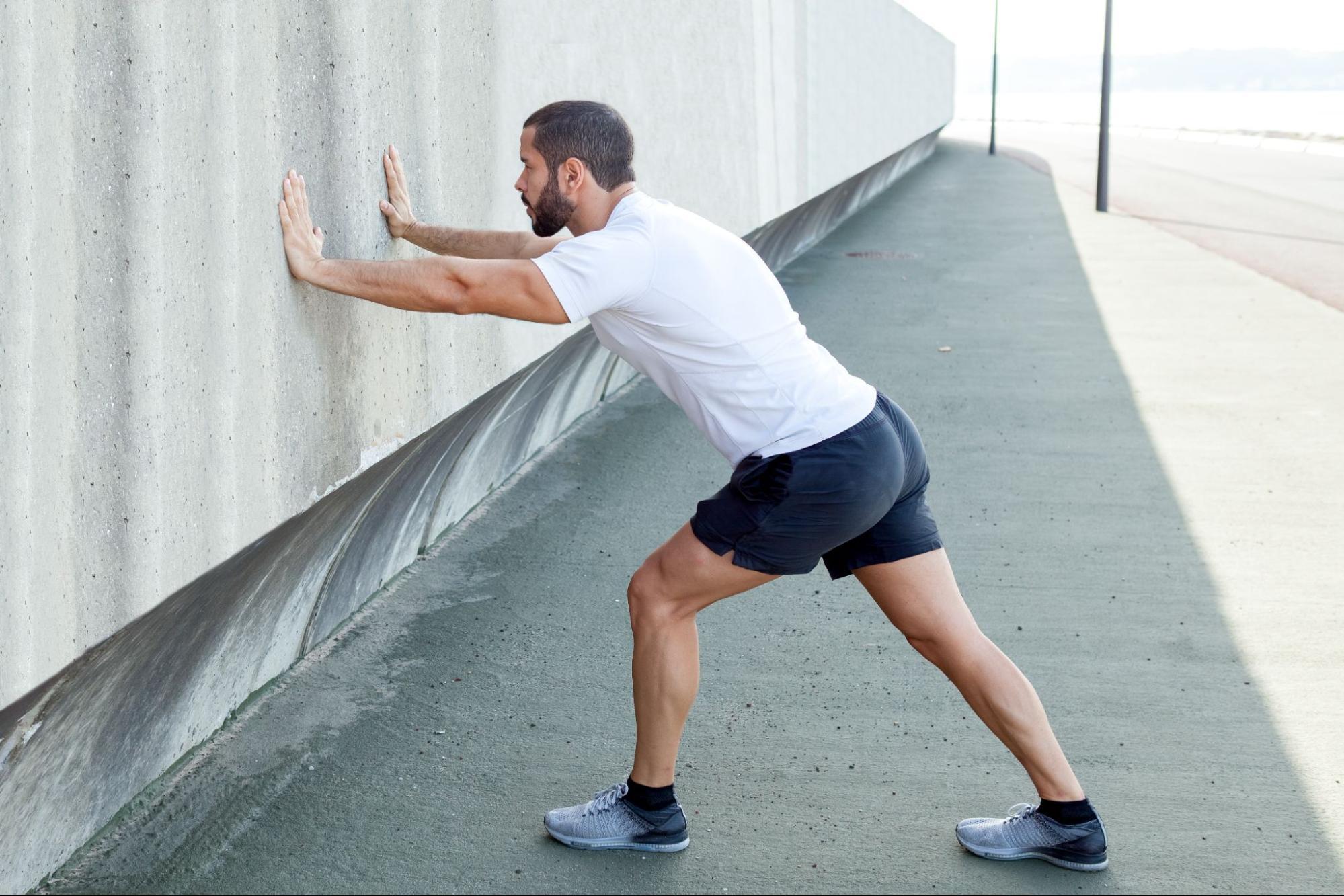 Wall calf stretch for cyclists after a ride