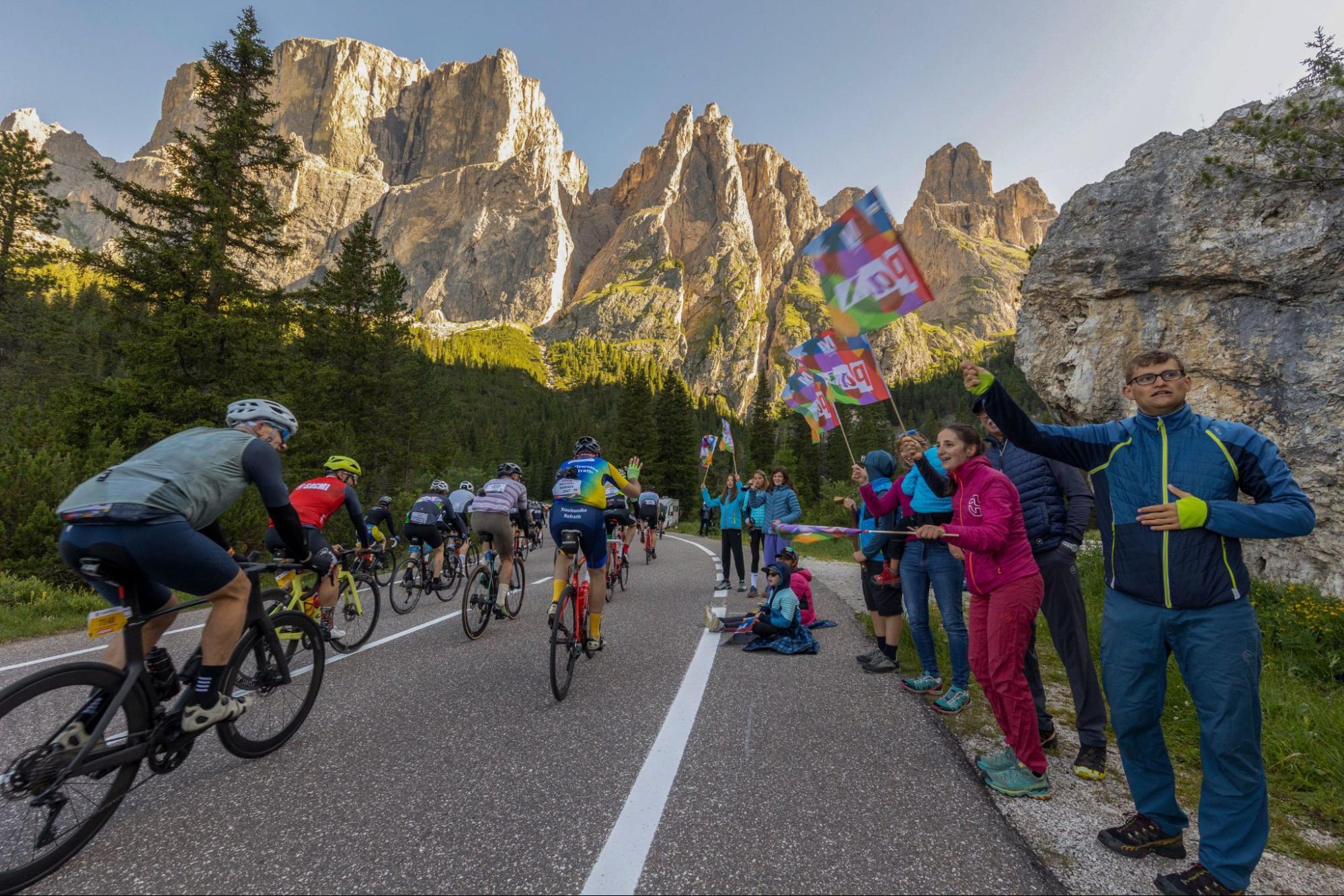 Spectators cheering riders on a climb at the Maratona dles Dolomites